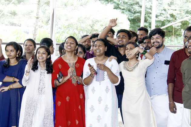 Edstem Technologies team members cheering and celebrating together during company Onam festival event
